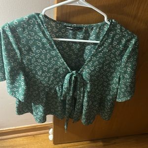 green flowy shirt with flowers- tie in the middle